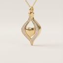 Gold pendant with heart design on a light beige background