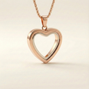 A rose gold heart-shaped pendant with a silver inner lining suspended from a matching chain against a minimalist off-white background.